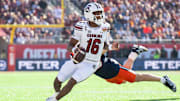 Dec 31, 2024; Orlando, FL, USA; South Carolina Gamecocks quarterback LaNorris Sellers (16) runs the ball against Illinois Fighting Illini linebacker Joe Barna (43) in the first quarter at Camping World Stadium. Mandatory Credit: Jeremy Reper-Imagn Images