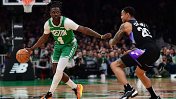 Mar 10, 2025; Boston, Massachusetts, USA; Boston Celtics guard Jrue Holiday (4) controls the ball while Utah Jazz forward John Collins (20) defends during the first half at TD Garden. Mandatory Credit: Bob DeChiara-Imagn Images