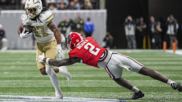 Nov 28, 2025; Atlanta, Georgia, USA; Georgia Tech Yellow Jackets running back Chad Alexander (27) runs against Georgia Bulldogs safety Zion Branch (2) during the second half at Mercedes-Benz Stadium. Mandatory Credit: Dale Zanine-Imagn Images