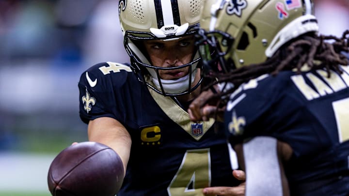 Sep 8, 2024; New Orleans, Louisiana, USA;  New Orleans Saints quarterback Derek Carr (4) hands off to running back Alvin Kamara (41) against the Carolina Panthers during the pregame at Caesars Superdome. Mandatory Credit: Stephen Lew-Imagn Images