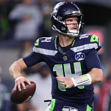 Oct 20, 2025; Seattle, Washington, USA; Seattle Seahawks quarterback Sam Darnold (14) looks to throw a pass during the second quarter against the Houston Texans at Lumen Field. Mandatory Credit: Kevin Ng-Imagn Images
