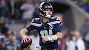 Oct 20, 2025; Seattle, Washington, USA; Seattle Seahawks quarterback Sam Darnold (14) looks to throw a pass during the second quarter against the Houston Texans at Lumen Field. Mandatory Credit: Kevin Ng-Imagn Images