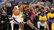 Jan 25, 2025; San Francisco, California, USA; Golden State Warriors guard Moses Moody (4) dribbles against Los Angeles Lakers forward LeBron James (center left) during the third quarter at Chase Center. Mandatory Credit: Darren Yamashita-Imagn Images