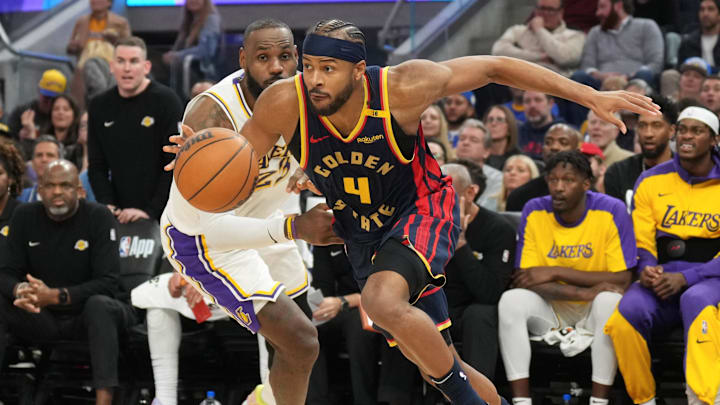 Jan 25, 2025; San Francisco, California, USA; Golden State Warriors guard Moses Moody (4) dribbles against Los Angeles Lakers forward LeBron James (center left) during the third quarter at Chase Center. Mandatory Credit: Darren Yamashita-Imagn Images