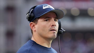 Seattle Seahawks head coach Mike Macdonald reviews the scoreboard