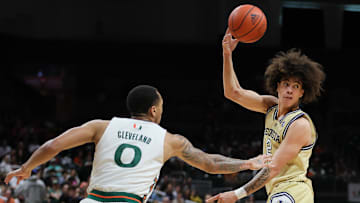 Feb 24, 2024; Coral Gables, Florida, USA; Georgia Tech Yellow Jackets guard Naithan George (2) passes the basketball as Miami Hurricanes guard Matthew Cleveland (0) defends during the first half at Watsco Center. Mandatory Credit: Sam Navarro-Imagn Images