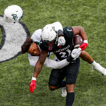 Oct 21, 2023; Cincinnati, Ohio, USA;Cincinnati Bearcats running back Corey Kiner (21) runs with the ball against Baylor Bears linebacker Garmon Randolph (55) in the second half at Nippert Stadium. Mandatory Credit: Katie Stratman-USA TODAY Sports