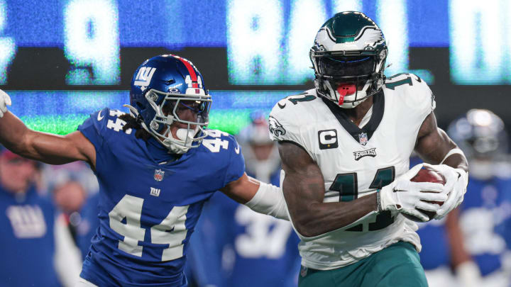 Jan 7, 2024; East Rutherford, New Jersey, USA; Philadelphia Eagles wide receiver A.J. Brown (11) catches the ball as New York Giants cornerback Nick McCloud (44) pursues during the first quarter at MetLife Stadium. Mandatory Credit: Vincent Carchietta-USA TODAY Sports