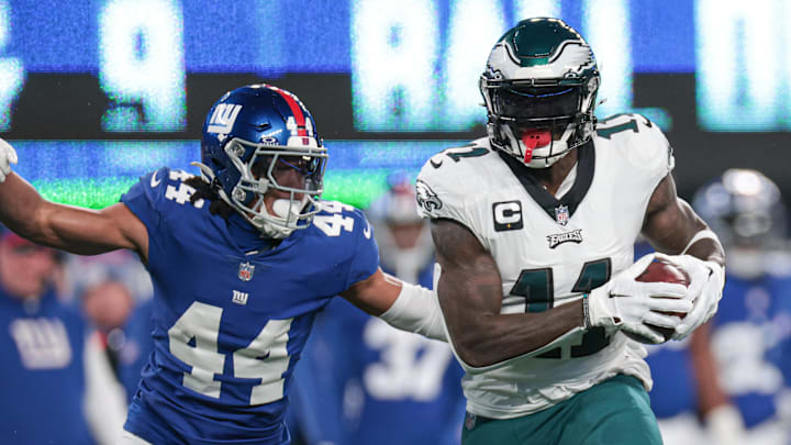 Jan 7, 2024; East Rutherford, New Jersey, USA; Philadelphia Eagles wide receiver A.J. Brown (11) catches the ball as New York Giants cornerback Nick McCloud (44) pursues during the first quarter at MetLife Stadium. Mandatory Credit: Vincent Carchietta-Imagn Images