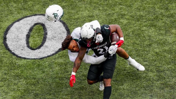 Oct 21, 2023; Cincinnati, Ohio, USA;Cincinnati Bearcats running back Corey Kiner (21) runs with the ball against Baylor Bears linebacker Garmon Randolph (55) in the second half at Nippert Stadium. Mandatory Credit: Katie Stratman-USA TODAY Sports