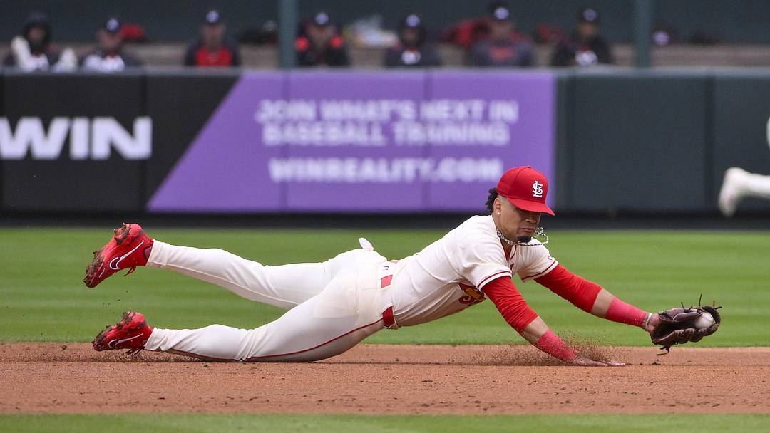Mar 29, 2025; St. Louis, Missouri, USA;  St. Louis Cardinals shortstop Masyn Winn (0) dives and fields a ground ball hit by Minnesota Twins shortstop Carlos Correa (not pictured) during the third inning at Busch Stadium. Mandatory Credit: Jeff Curry-Imagn Images