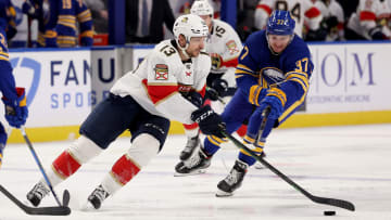 Apr 3, 2022; Buffalo, New York, USA;  Florida Panthers center Sam Reinhart (13) controls the puck as Buffalo Sabres center Casey Mittelstadt (37) tries to defend during the third period at KeyBank Center. Mandatory Credit: Timothy T. Ludwig-USA TODAY Sports