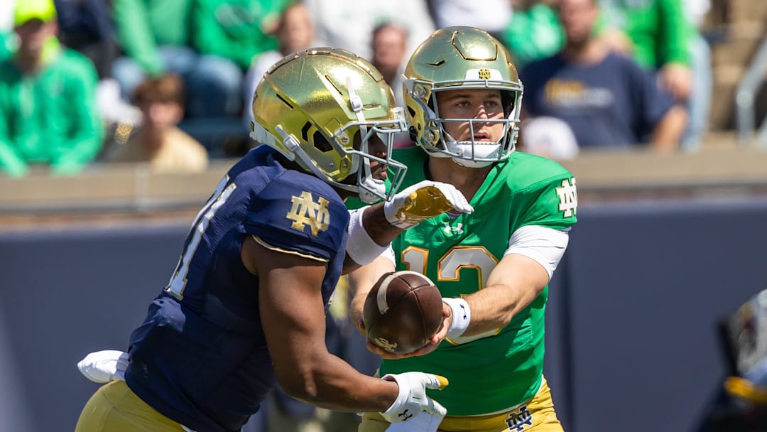 Apr 12, 2025; Notre Dame, IN, USA; Notre Dame Fighting Irish quarterback CJ Carr (right) hands off to running back Kedren Young (left)  during the Blue-Gold game at Notre Dame Stadium. Mandatory Credit: Michael Caterina-Imagn Images