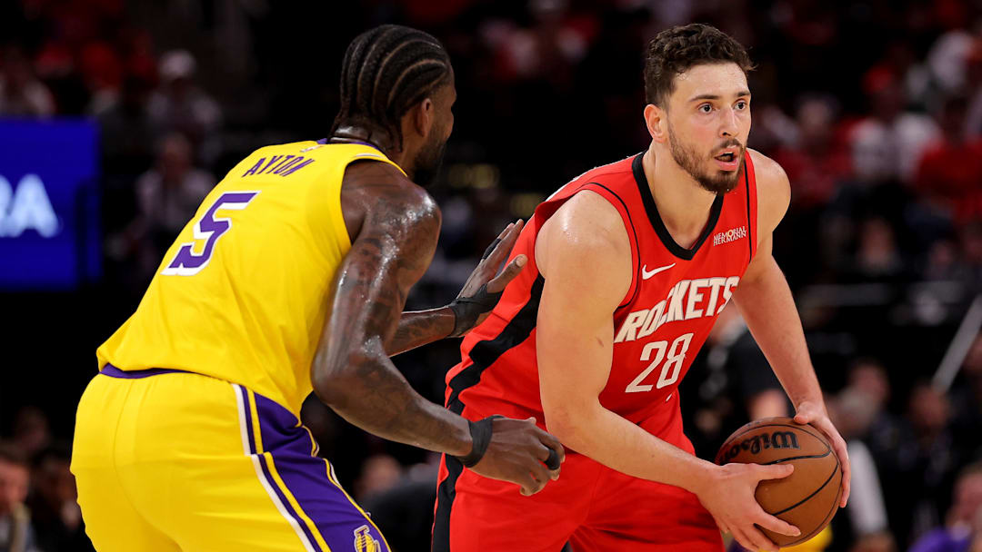 May 1, 2026; Houston, Texas, USA; Houston Rockets center Alperen Sengun (28) handles the ball against Los Angeles Lakers center Deandre Ayton (5) during the first quarter game six of the first round of the 2026 NBA Playoffs at Toyota Center. Mandatory Credit: Erik Williams-Imagn Images