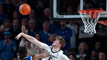 Vanderbilt Commodores guard Tyler Nickel (5) pressures the shot of Kentucky Wildcats guard Otega Oweh (00) during their game at Memorial Gym in Nashville, Tenn., Saturday, Jan. 25, 2025.