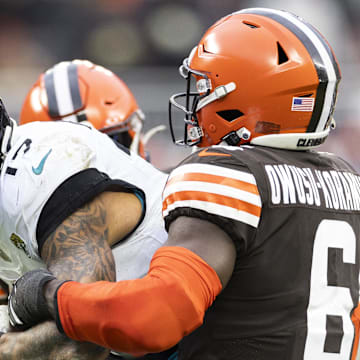 Dec 10, 2023; Cleveland, Ohio, USA; Jacksonville Jaguars tight end Evan Engram (17) is tackled by Cleveland Browns linebacker Jeremiah Owusu-Koramoah (6) as he runs the ball during the fourth quarter at Cleveland Browns Stadium. Mandatory Credit: Scott Galvin-Imagn Images