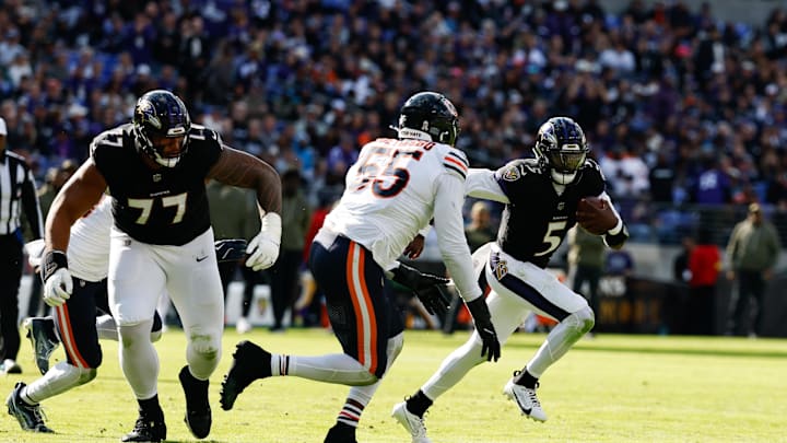 Oct 26, 2025; Baltimore, Maryland, USA; Baltimore Ravens quarterback Tyler Huntley (5) runs with the ball as Chicago Bears defensive end Dayo Odeyingbo (55) chases in the third quarter at M&T Bank Stadium. Mandatory Credit: Geoff Burke-Imagn Images