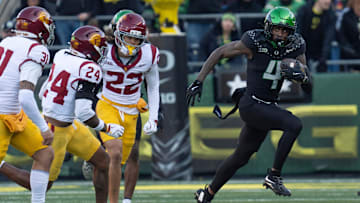 Oregon’s Malik Benson, right, breaks the USC coverage on a punt return for a touchdown.