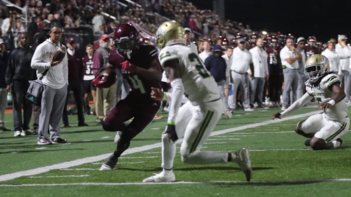 Benedictine's Bubba Frazier lowers his shoulder as he races to the end zone against Ware County's Cameron King on Friday October 11, 2024 at Memorial Stadium.