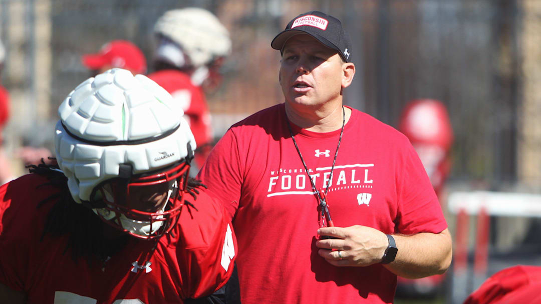 Wisconsin offensive line coach AJ Blazek works with Manny Mullens (58) during spring practice outside Camp Randall Stadium in Madison, Wisconsin on Saturday April 13, 2024