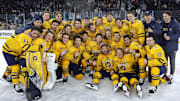 The Quinnipiac men's hockey team celebrates winning the Belpot Trophy at the 2022 Friendship Four in Belfast, Ireland. 