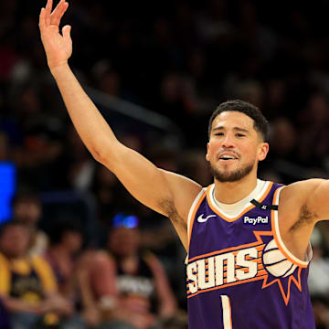 Apr 8, 2025; Phoenix, Arizona, USA; Phoenix Suns guard Devin Booker (1) reacts against the Golden State Warriors at Footprint Center. Mandatory Credit: Mark J. Rebilas-Imagn Images