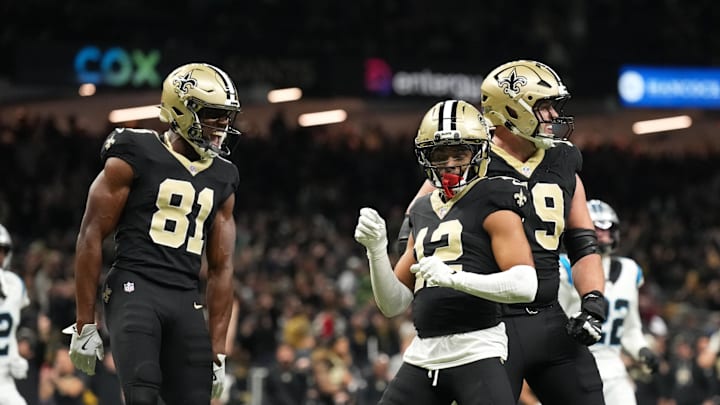 Dec 14, 2025; New Orleans, Louisiana, USA; New Orleans Saints wide receiver Chris Olave (12) celebrates with teammates after scoring a touchdown in the fourth quarter against the Carolina Panthers at Caesars Superdome. Mandatory Credit: Matthew Hinton-Imagn Images