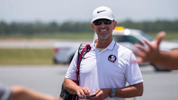 Florida State baseball coach Link Jarrett boards a plane with his team as they leave to play in the College World Series in Omaha, Nebraska, Wednesday, June 12, 2024.