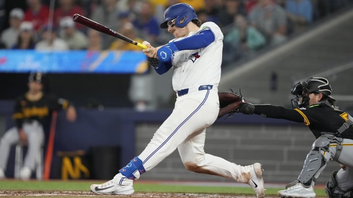 Jun 2, 2024; Toronto, Ontario, CAN; Toronto Blue Jays catcher Danny Jansen (9) hits a single against the Pittsburgh Pirates during the third inning at Rogers Centre. Mandatory Credit: John E. Sokolowski-USA TODAY Sports