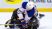 Jan 18, 2025; Vancouver, British Columbia, CAN; Edmonton Oilers forward Connor McDavid (97) battles with Vancouver Canucks forward Conor Garland (8) in the third period at Rogers Arena. Mandatory Credit: Bob Frid-Imagn Images
