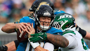 Jacksonville Jaguars quarterback Mac Jones (10) steps up in the pocket to run as pressured by New York Jets defensive tackle Quinnen Williams (95) during the second quarter Sunday, Dec. 15, 2024 at EverBank Stadium in Jacksonville, Fla. 