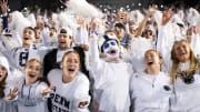 Penn State students sing along to a song during the White Out football game against Iowa at Beaver Stadium.