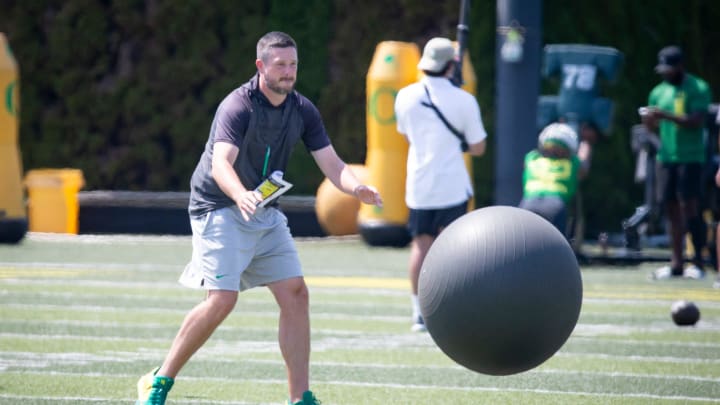 Oregon head coach Dan Lanning throws a large ball at returners during kick return drills during practice with the Oregon Ducks Friday, Aug. 9, 2024 at the Hatfield-Dowlin Complex in Eugene, Ore.