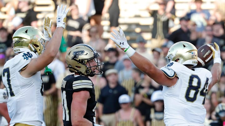 Notre Dame Fighting Irish tight end Cooper Flanagan (87) and Notre Dame Fighting Irish tight end Kevin Bauman (84) celebrates in front of Purdue Boilermakers defensive back Dillon Thieneman (31) after a Notre Dame Fighting Irish touchdown Saturday, Sept. 14, 2024, during the NCAA football game at Ross-Ade Stadium in West Lafayette, Ind. Notre Dame Fighting Irish won 66-7.