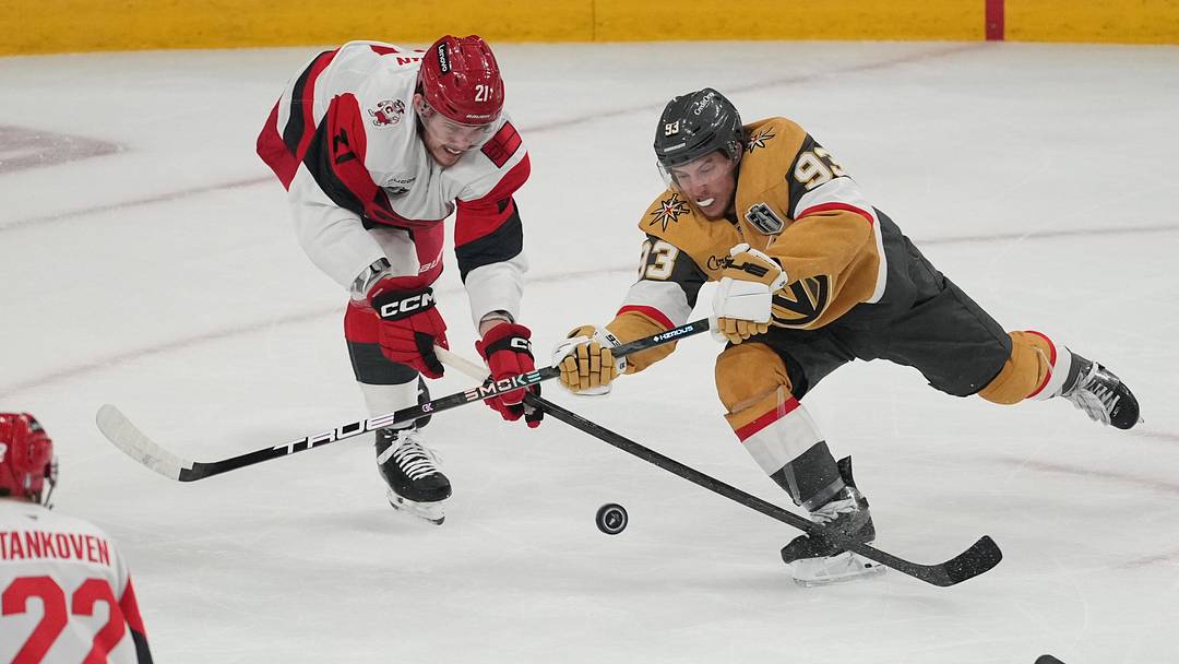 Jun 14, 2026; Las Vegas, Nevada, USA; Vegas Golden Knights right wing Mitch Marner (93) reaches for the puck against Carolina Hurricanes defenseman Alexander Nikishin (21) during the first period in game six of the 2026 Stanley Cup Final at T-Mobile Arena. Mandatory Credit: Lucas Peltier-Imagn Images