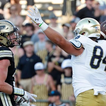 Notre Dame Fighting Irish tight end Cooper Flanagan (87) and Notre Dame Fighting Irish tight end Kevin Bauman (84) celebrates in front of Purdue Boilermakers defensive back Dillon Thieneman (31) after a Notre Dame Fighting Irish touchdown Saturday, Sept. 14, 2024, during the NCAA football game at Ross-Ade Stadium in West Lafayette, Ind. Notre Dame Fighting Irish won 66-7.