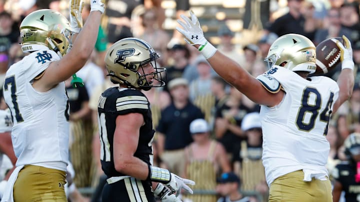 Notre Dame Fighting Irish tight end Cooper Flanagan (87) and Notre Dame Fighting Irish tight end Kevin Bauman (84) celebrates in front of Purdue Boilermakers defensive back Dillon Thieneman (31) after a Notre Dame Fighting Irish touchdown Saturday, Sept. 14, 2024, during the NCAA football game at Ross-Ade Stadium in West Lafayette, Ind. Notre Dame Fighting Irish won 66-7.