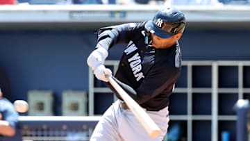 Mar 15, 2025; Port Charlotte, Florida, USA;  New York Yankees designated hitter Dominic Smith (22) hits a RBI during the third inning against the Tampa Bay Rays at Charlotte Sports Park. Mandatory Credit: Kim Klement Neitzel-Imagn Images