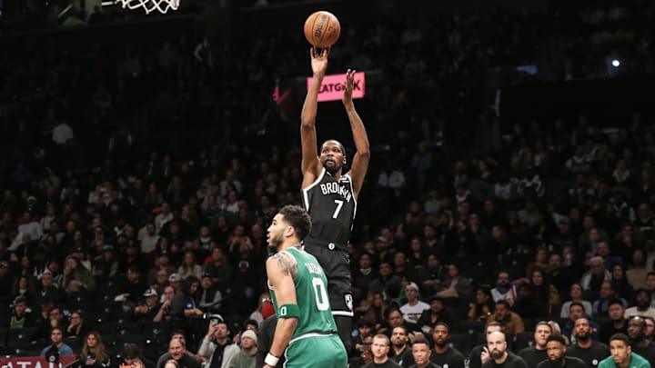 Durant shoots a three-pointer over Jayson Tatum.