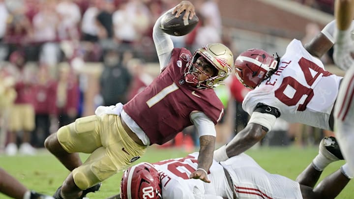 Florida State Seminoles quarterback Tommy Castellanos loses his footing against Alabama Crimson Tide linebacker Jah-Marien Latham Florida State Seminoles quarterback Tommy Castellanos loses his footing against Alabama Crimson Tide linebacker Jah-Marien Latham