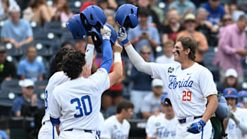 Jun 19, 2024; Omaha, NE, USA;  Florida Gators designated hitter Brody Donay (29) celebrates hitting a grand slam with right fielder Ashton Wilson (30) against the Kentucky Wildcats during the first inning at Charles Schwab Field Omaha. Mandatory Credit: Steven Branscombe-Imagn Images