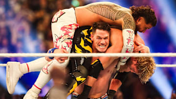 John Cena lifts Jey Uso and Logan Paul on his shoulders Saturday, Feb. 1, 2025, during the WWE Royal Rumble at Lucas Oil Stadium in Indianapolis.