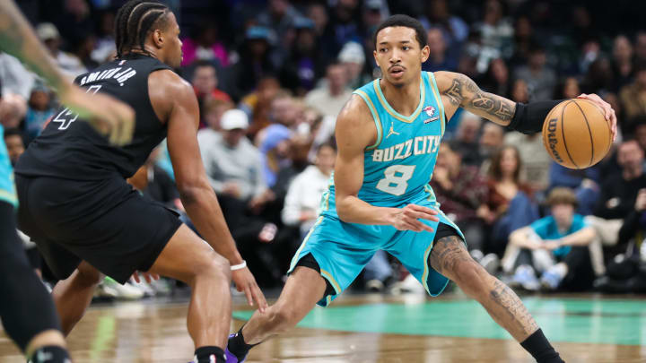 Mar 9, 2024; Charlotte, North Carolina, USA;  Charlotte Hornets guard Nick Smith Jr. (8) drives the play against Brooklyn Nets guard Dennis Smith Jr. (4) during the third quarter at Spectrum Center. Mandatory Credit: Cory Knowlton-USA TODAY Sports