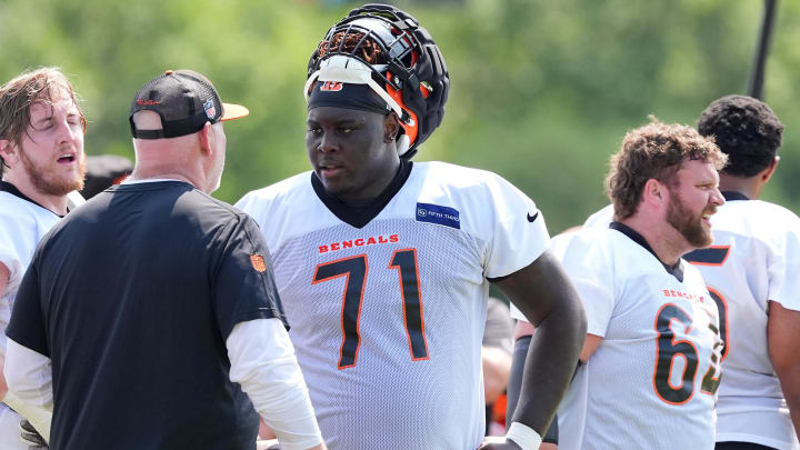 Jul 26, 2024; Cincinnati, OH, USA;  Cincinnati Bengals offensive tackle Amarius Mims (71) talks with offensive line coach Frank Pollack during training camp practice at Kettering Health Practice Fields. Mandatory Credit: Kareem Elgazzar-USA TODAY Sports