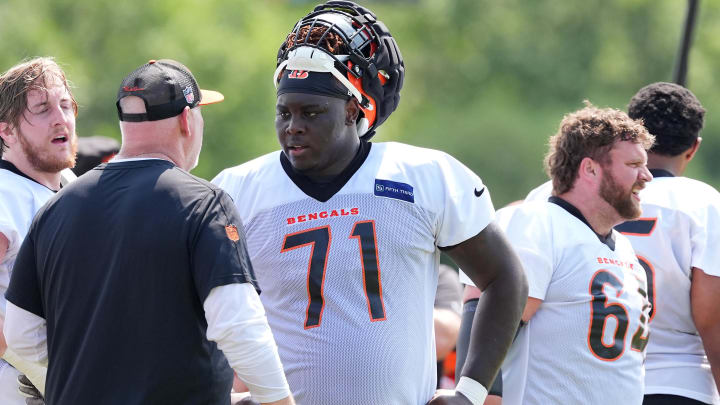 Jul 26, 2024; Cincinnati, OH, USA;  Cincinnati Bengals offensive tackle Amarius Mims (71) talks with offensive line coach Frank Pollack during training camp practice at Kettering Health Practice Fields. Mandatory Credit: Kareem Elgazzar-USA TODAY Sports