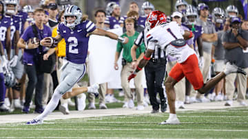 Sep 13, 2024; Manhattan, Kansas, USA; Kansas State Wildcats quarterback Avery Johnson (2) is forced out of bounds by Arizona Wildcats defensive back Tacario Davis (1) during the third quarter at Bill Snyder Family Football Stadium. Mandatory Credit: Scott Sewell-Imagn Images