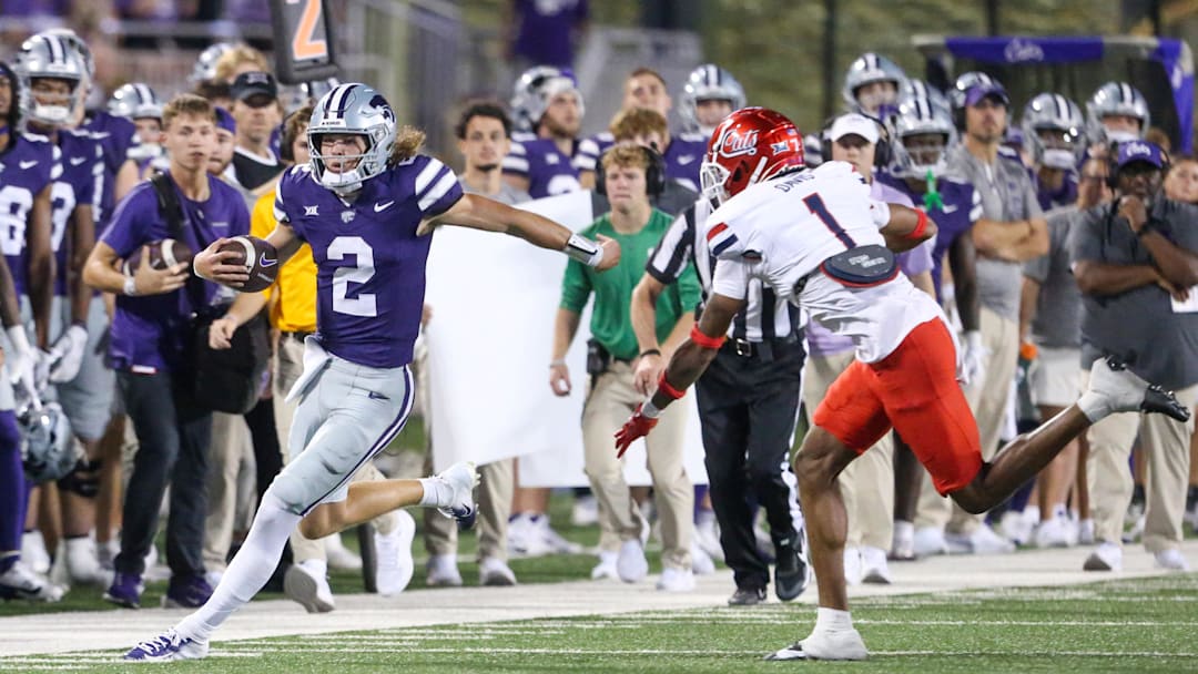 Sep 13, 2024; Manhattan, Kansas, USA; Kansas State Wildcats quarterback Avery Johnson (2) is forced out of bounds by Arizona Wildcats defensive back Tacario Davis (1) during the third quarter at Bill Snyder Family Football Stadium.