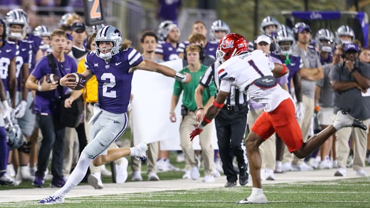 Sep 13, 2024; Manhattan, Kansas, USA; Kansas State Wildcats quarterback Avery Johnson (2) is forced out of bounds by Arizona Wildcats defensive back Tacario Davis (1) during the third quarter at Bill Snyder Family Football Stadium.