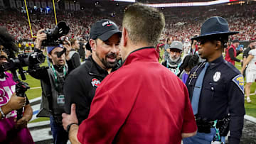Ohio State Buckeyes head coach Ryan Day and Indiana Hoosiers head coach Curt Cignetti shake hands Sunday, Dec. 7, 2025, after the Big Ten football championship at Lucas Oil Stadium in Indianapolis.