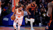Dec 11, 2024; New York, New York, USA; Atlanta Hawks guard Trae Young (11) brings the ball up court against New York Knicks center Karl-Anthony Towns (32) during the first quarter at Madison Square Garden. Mandatory Credit: Brad Penner-Imagn Images